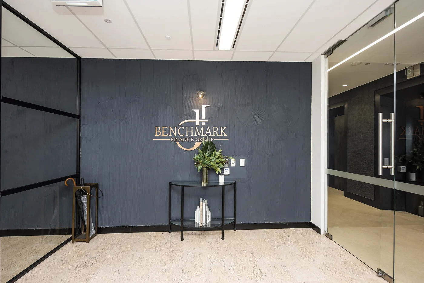 Benchmark — Reception wall and glazed meeting suite.